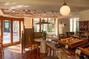 a kitchen with a table and chairs and a dining room at Salvia Paris in Paris