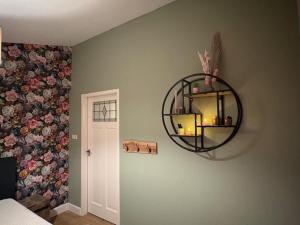 a room with a mirror on the wall with a bed at B&B Chili Hoeve in Wanroij