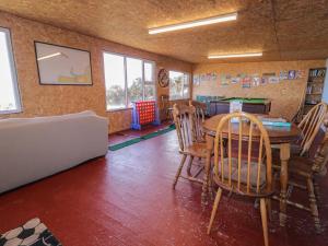 a room with a table and chairs in a room at Cabin 7 Toraigh in Gortahork