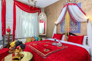 a bedroom with a red bed with a red blanket at Hotel Ipek Palas in Istanbul