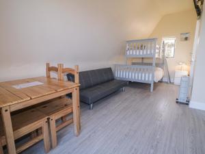 a living room with a couch and a table at Cabin 9 Inis Beag in Gortahork