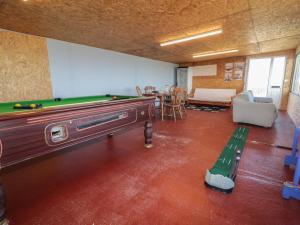 a living room with a pool table and a table at Cabin 9 Inis Beag in Gortahork