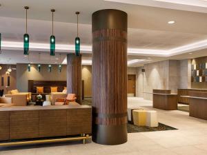 a lobby of a hotel with a column at Pullman Rotorua in Rotorua