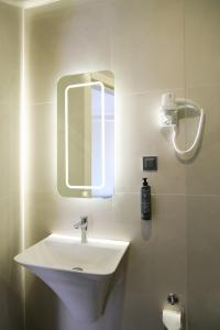 a bathroom with a white sink and a mirror at Hotel Ipek Palas in Istanbul +29 photos