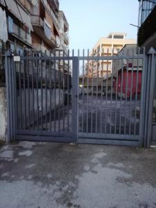 a metal gate in front of a building at Casa Sambuco in Volla