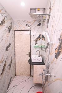 a bathroom with a shower and a sink at D. K. INTERNATIONAL HOTEL PVT. LTD in Calcutta Bara Bazar +141 photos