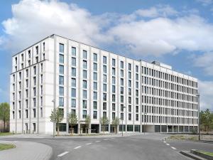 a large white building with a lot of windows at smartments Frankfurt Airport in Frankfurt