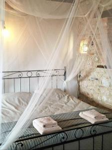 a bedroom with a bed with mosquito netting at Casa Zampani in Massa Martana