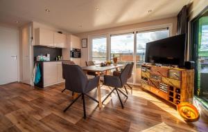 a kitchen and dining room with a table and chairs at Floatinghouse Skyline in Klitten