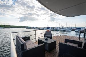 a person sitting on the deck of a boat at Floatinghouse Hideaway LP25 in Klitten