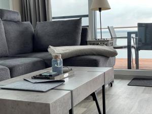 a living room with a couch and a coffee table at Floatinghouse Möwenblick - LP1 in Vetschau