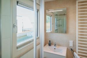 a bathroom with a sink and a mirror at Floatinghouse Seelenbaumler - LP13 in Vetschau +29 photos