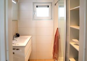 a bathroom with a sink and a window at Floatinghouse Bernstein Suite in Ribnitz-Damgarten +29 photos