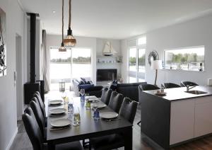 a dining room and living room with a table and chairs at Floatinghouse Ankerplatz in Ribnitz-Damgarten