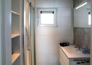 a bathroom with a sink and a window at Floatinghouse Ankerplatz in Ribnitz-Damgarten +25 photos