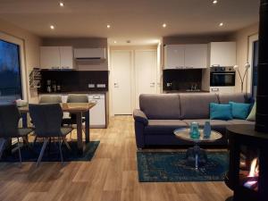 a living room with a couch and a table at Floatinghouse KonTiki - LP8 in Vetschau