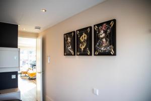 four framed pictures on a wall in a kitchen at Floatinghouse Bahama Mama in Klitten