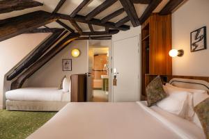 a bedroom with two beds in a room at Salvia Paris in Paris