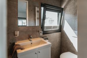 a bathroom with a sink and a mirror at Floatinghouse Red Pearl in Zehdenick +37 photos