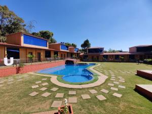 a resort with a swimming pool in the yard at Arya Resort And Spaa in Mahabaleshwar +11 photos