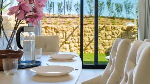 a white table with white dishes and a bottle of water at CAMPOROSSO magic apartment in Finestrat