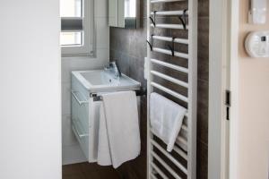 a bathroom with a sink and a white towel rack at Floatinghouse King - LP5 in Vetschau +32 photos