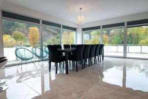 a dining room with a black table and chairs at Villa Boomerang in Srbljani