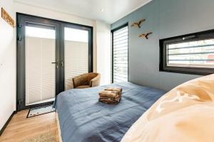 a bedroom with a bed with a bag on it at Floatinghouse Topas in Zehdenick