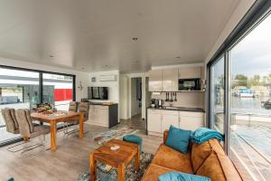 a living room with a couch and a table at Floatinghouse Topas in Zehdenick +24 photos