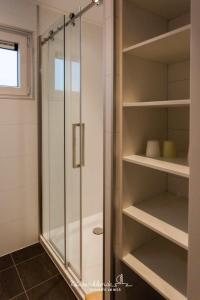 a shower in a bathroom with a glass door at Floatinghouse Boddenperle in Ribnitz-Damgarten +26 photos