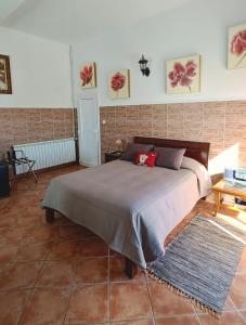a bedroom with a bed and a brick wall at Bela Vista in Paradela