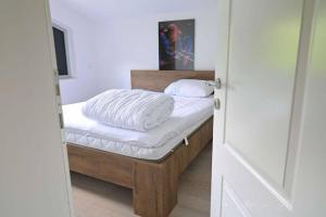 a bedroom with a bed with white sheets at Villa Boomerang in Srbljani +45 photos