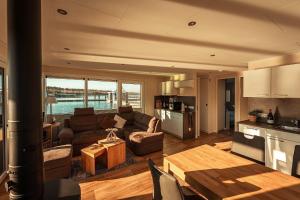 a living room with a couch and a table at Floatinghouse Möwenschiss in Klitten