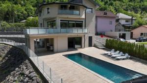 a large house with a swimming pool in front of it at Villa Boomerang in Srbljani
