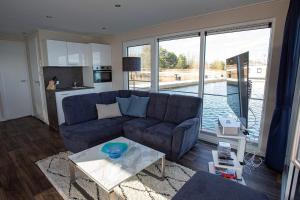 a living room with a couch and a table at Floatinghouse Dolce Vita - LP10 in Vetschau
