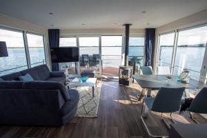 a living room with a view of the ocean at Floatinghouse Dolce Vita - LP10 in Vetschau