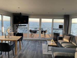 a living room with a view of the ocean at Floatinghouse Neptun - LP3 in Vetschau