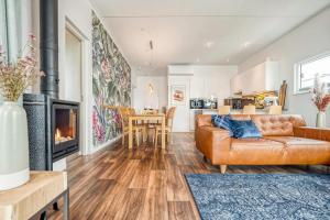 a living room with a couch and a fireplace at Floatinghouse Große Freiheit in Ribnitz-Damgarten