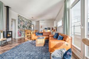 a living room with a couch and a table at Floatinghouse Große Freiheit in Ribnitz-Damgarten +31 photos