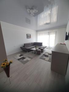 a living room with a couch and a table at Constantin Rooms in Eforie Nord