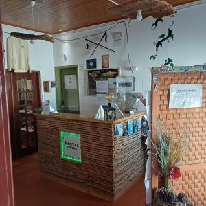 a restaurant with a counter in a room at Hostel Nature - Zambujeira do Mar in Zambujeira do Mar