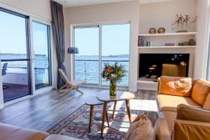 a living room with a couch and a table at Floatinghouse Meerkraft in Ribnitz-Damgarten