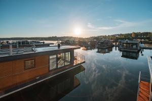 a group of boats sitting on the water at Floatinghouse Vroni in Klitten
