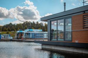 a building next to a body of water at Floatinghouse Vroni in Klitten