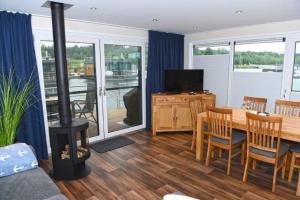 a living room with a wood stove and a table at Floatinghouse Vroni in Klitten