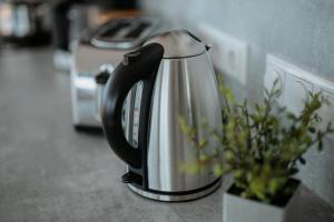 a tea kettle sitting on a counter with a plant at Floatinghouse Cosy Home - LP16 in Vetschau