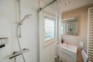 a bathroom with a shower and a sink at Floatinghouse Seeblick - LP7 in Vetschau +28 photos