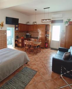 a room with a bed and a table and a kitchen at Bela Vista in Paradela
