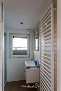 a bathroom with a sink and a window at Floatinghouse Dory in Ribnitz-Damgarten