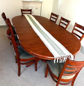 a wooden table with a napkin on top of it at Waterfront Retreat Mooloolaba in Mooloolaba
